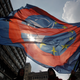 A man waves an anti NATO and EU flag during an anti NATO rally in downtown Belgrade, Serbia, March 27, 2016. Thousands marched against NATO and the West in Serbia, carrying pro-Russian banners praising Russian President Vladimir Putin. Pro-Russian forces in Serbia have been gaining ground ahead of the April 24 general election that could decide which way Serbia is heading, toward Russia or EU. (AP Photo/Andrej Cukic)